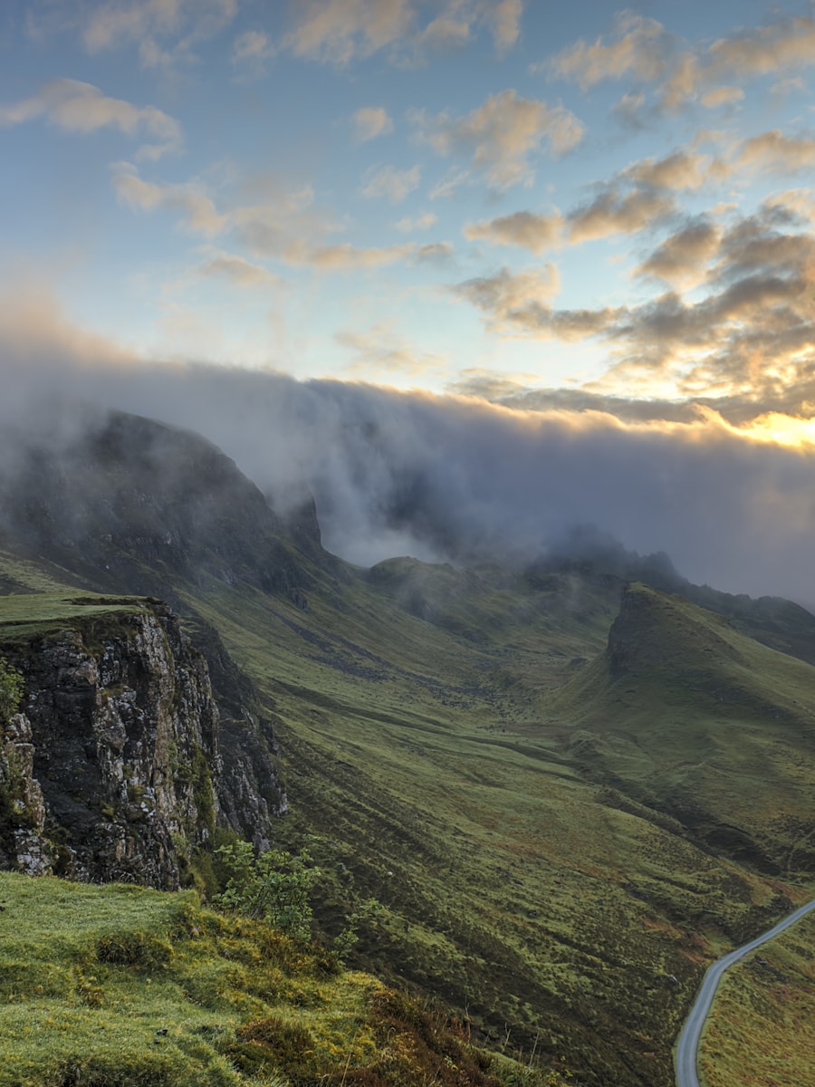Mist rolling over green moorland hills