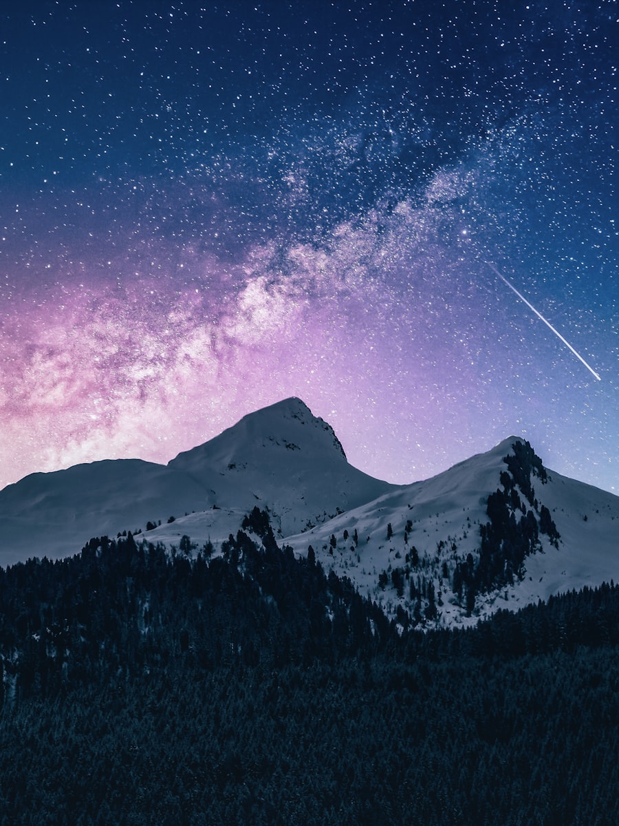 Dark mountains beneath a starry night sky