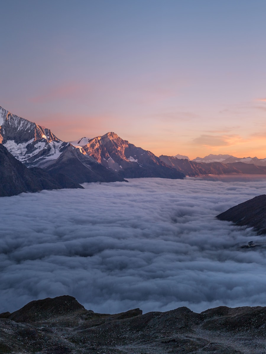 A snow-covered peak rising above the clouds
